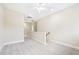 Bright loft space featuring neutral walls, plush carpet, a ceiling fan, and a hallway with access to other rooms at 1090 Indigo Ridge Pl, Cary, NC 27519