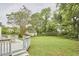 Large backyard featuring a spacious deck, a well-manicured lawn, and mature trees for added privacy at 1104 Englewood Ave, Durham, NC 27701