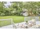 Spacious backyard with lush greenery, a wooden deck, and a storage shed in the background at 1104 Englewood Ave, Durham, NC 27701