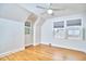 Cozy bedroom with hardwood floors, unique sloped ceilings, and bright windows letting in natural light at 1104 Englewood Ave, Durham, NC 27701