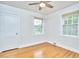 Bedroom with hardwood flooring, neutral walls, ceiling fan, and large windows for ample natural light at 1104 Englewood Ave, Durham, NC 27701