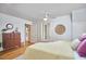 Bright primary bedroom featuring natural light, wood floors, and a connecting bathroom at 1104 Englewood Ave, Durham, NC 27701