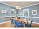 Elegant dining room boasts a wooden table, blue chairs, and abundant natural light at 1104 Englewood Ave, Durham, NC 27701