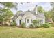 Exterior view showcasing a landscaped front yard and well-kept facade with bright white cladding at 1104 Englewood Ave, Durham, NC 27701