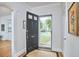 Inviting foyer with hardwood floors and natural light coming from the entry's storm door at 1104 Englewood Ave, Durham, NC 27701