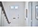 Entryway featuring white front door with glass panes, and sidelight windows on a staircase landing at 1104 Englewood Ave, Durham, NC 27701