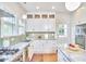 Updated kitchen boasts white cabinets, stainless steel appliances, and a green tile backsplash at 1104 Englewood Ave, Durham, NC 27701
