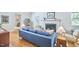 Elegant living room with hardwood floors, a fireplace, and a comfortable blue sofa at 1104 Englewood Ave, Durham, NC 27701
