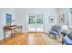Bright living room with French doors to deck, light hardwood floors, and comfortable furnishings at 1104 Englewood Ave, Durham, NC 27701