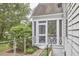 View of the exterior screened porch, attached to the home's foundation with metal safety railing at 1104 Englewood Ave, Durham, NC 27701