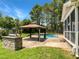Beautiful backyard featuring a pool, gazebo, and outdoor kitchen at 1201 Dagmar Ln, Wake Forest, NC 27587