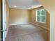 Neutral bedroom with gray carpet, window letting in lots of light, and recessed ceiling fan at 1201 Dagmar Ln, Wake Forest, NC 27587