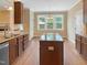 Well-appointed kitchen with a central island, granite counters, and open dining area at 1201 Dagmar Ln, Wake Forest, NC 27587