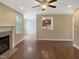 Open-concept living room with hardwood floors, fireplace, and great natural light at 1201 Dagmar Ln, Wake Forest, NC 27587