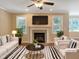 Bright and airy living room with fireplace, plush seating, and hardwood floors at 1201 Dagmar Ln, Wake Forest, NC 27587