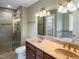 This bathroom has a double sink vanity, a glass door shower, and neutral walls at 1201 Dagmar Ln, Wake Forest, NC 27587