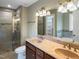This bathroom has a double sink vanity, a glass door shower, and neutral walls at 1201 Dagmar Ln, Wake Forest, NC 27587