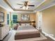 This main bedroom offers a ceiling fan, neutral walls, a cozy bed and great natural light at 1201 Dagmar Ln, Wake Forest, NC 27587