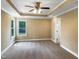 This main bedroom is spacious and has neutral walls, a ceiling fan and a window at 1201 Dagmar Ln, Wake Forest, NC 27587