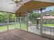 Cozy screened porch with wood floors, offering an excellent outdoor space at 1201 Dagmar Ln, Wake Forest, NC 27587