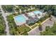 Aerial view of community pool area offering multiple pools, ample seating, and well-maintained landscaping at 124 Kingsport Rd, Holly Springs, NC 27540