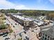 Expansive aerial view of commercial properties, buildings, and parking lots on a sunny day with light traffic at 124 Kingsport Rd, Holly Springs, NC 27540
