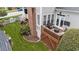 A beautifully landscaped backyard with a wood deck, patio furniture, and lush greenery at 124 Kingsport Rd, Holly Springs, NC 27540