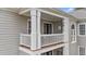 Inviting outdoor balcony area featuring white railing and columns, and decorative accents at 124 Kingsport Rd, Holly Springs, NC 27540
