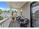 Charming balcony with woven chairs, a patterned rug, and view of the neighborhood at 124 Kingsport Rd, Holly Springs, NC 27540