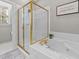 Bathroom featuring a gold trimmed glass-enclosed shower and a jacuzzi style bathtub at 124 Kingsport Rd, Holly Springs, NC 27540