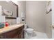 Cozy powder room featuring a decorative mirror and vanity with granite counters at 124 Kingsport Rd, Holly Springs, NC 27540