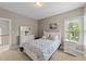Comfortable bedroom with furniture, window, and carpet at 124 Kingsport Rd, Holly Springs, NC 27540