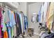 Well-organized walk-in closet with ample hanging space and shelving for storage at 124 Kingsport Rd, Holly Springs, NC 27540