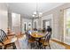 Elegant dining room featuring a wooden table with a checkered runner and a chandelier at 124 Kingsport Rd, Holly Springs, NC 27540