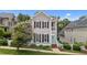 Classic two-story home boasting gray siding, black shutters, a quaint porch, and a well-maintained front yard at 124 Kingsport Rd, Holly Springs, NC 27540