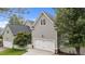 Attached two-car garage with white doors and trim, complemented by neat landscaping at 124 Kingsport Rd, Holly Springs, NC 27540