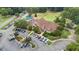 Aerial view of a golf course and clubhouse featuring a well-manicured putting green and parking at 124 Kingsport Rd, Holly Springs, NC 27540