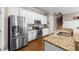 Kitchen features stainless steel appliances, granite countertops, and a modern design at 124 Kingsport Rd, Holly Springs, NC 27540