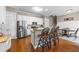 Well-lit kitchen with stainless steel appliances, granite countertops, and barstool seating at 124 Kingsport Rd, Holly Springs, NC 27540