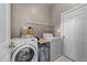 Functional laundry room with washer, dryer, shelving, and storage options at 124 Kingsport Rd, Holly Springs, NC 27540