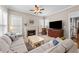 Bright living room features a fireplace, large windows, and an open layout at 124 Kingsport Rd, Holly Springs, NC 27540