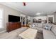 Open-concept living room with views of the kitchen, hardwood floors, and lots of natural light at 124 Kingsport Rd, Holly Springs, NC 27540