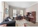Bright office features hardwood floors, two desks, a comfortable couch, and natural light at 124 Kingsport Rd, Holly Springs, NC 27540