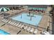 Community pool featuring a splash pad, sun loungers, and tables with umbrellas at 124 Kingsport Rd, Holly Springs, NC 27540