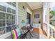 A cozy porch features an outdoor seating area with a table, a colorful pillow, and stylish decorative elements at 124 Kingsport Rd, Holly Springs, NC 27540