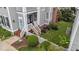 Charming porch with comfortable outdoor seating, a blue door, and lush greenery surrounding the entrance at 124 Kingsport Rd, Holly Springs, NC 27540