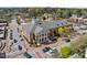 Historic building featuring brick facade, architectural detail, surrounded by a bustling downtown street with trees and parking at 124 Kingsport Rd, Holly Springs, NC 27540