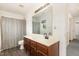 Well-lit bathroom featuring a shower-tub combo, undermount sink, and wood vanity at 128 Palmdale Ct, Holly Springs, NC 27540