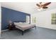 This bedroom features a blue accent wall, and a window allowing ample natural light at 128 Palmdale Ct, Holly Springs, NC 27540