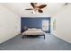 Bedroom featuring a blue accent wall and a ceiling fan with lighting at 128 Palmdale Ct, Holly Springs, NC 27540